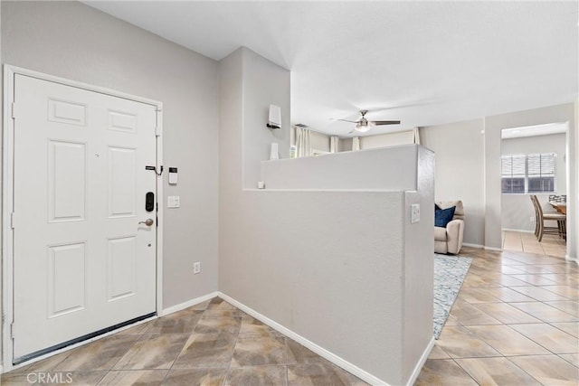 entryway featuring ceiling fan and light tile patterned floors