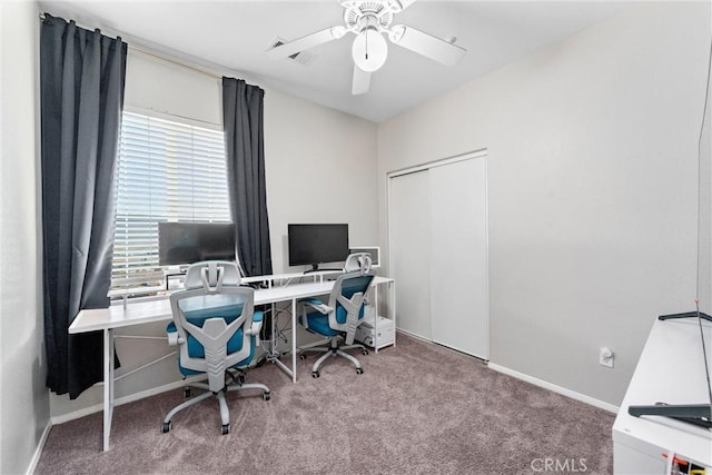 carpeted office featuring plenty of natural light and ceiling fan