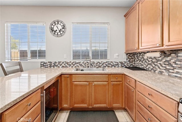 kitchen with beverage cooler, tasteful backsplash, and light stone countertops
