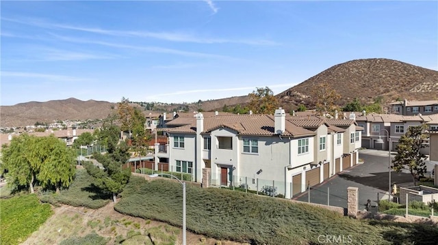 view of mountain background featuring nearby suburban area