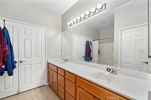 bathroom with double vanity, tile patterned flooring, and curtained shower