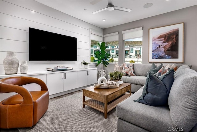 living room featuring ceiling fan and light hardwood / wood-style flooring