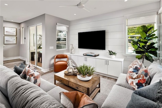 living room featuring light wood-type flooring and ceiling fan