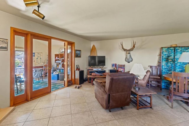 living room featuring french doors and light tile patterned flooring