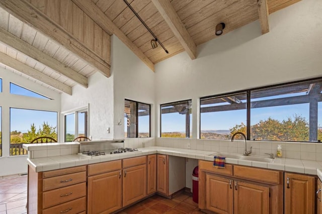 kitchen with wood ceiling, sink, tile countertops, and white gas stovetop