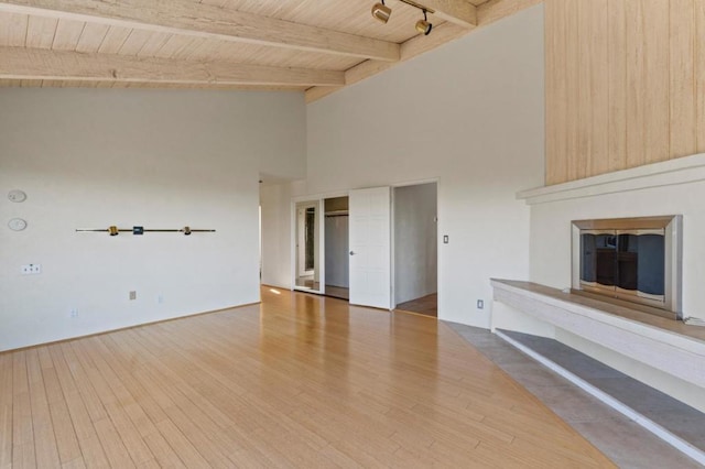 unfurnished living room featuring wooden ceiling, beam ceiling, and hardwood / wood-style floors