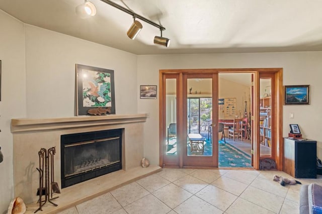 living room featuring tile patterned flooring and rail lighting