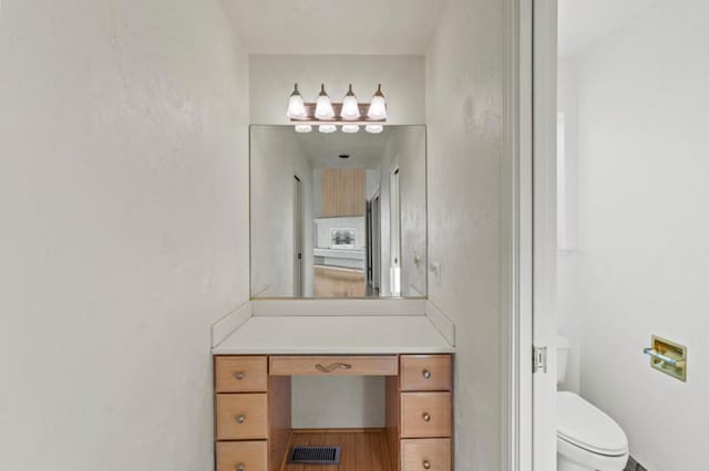 bathroom featuring toilet and vanity