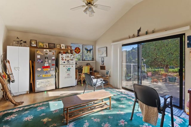 living room featuring ceiling fan, wood-type flooring, and vaulted ceiling