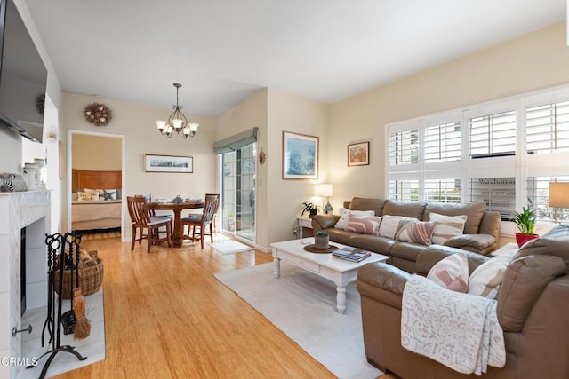 living room featuring a chandelier and light hardwood / wood-style floors