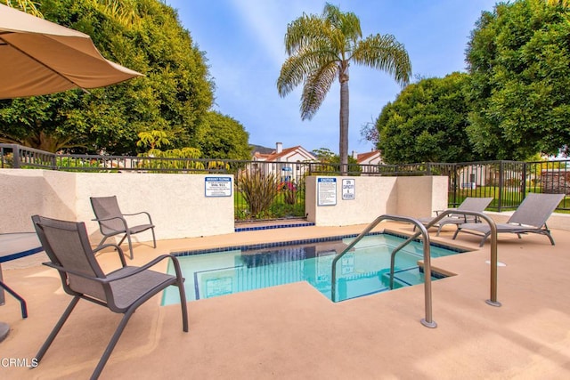 view of swimming pool with a patio area and a community hot tub