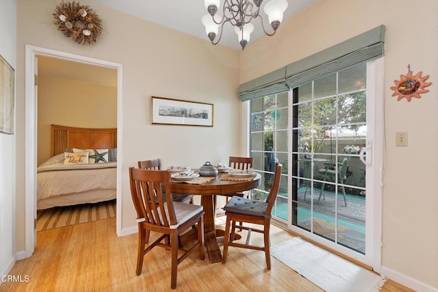 dining area featuring light hardwood / wood-style floors and an inviting chandelier