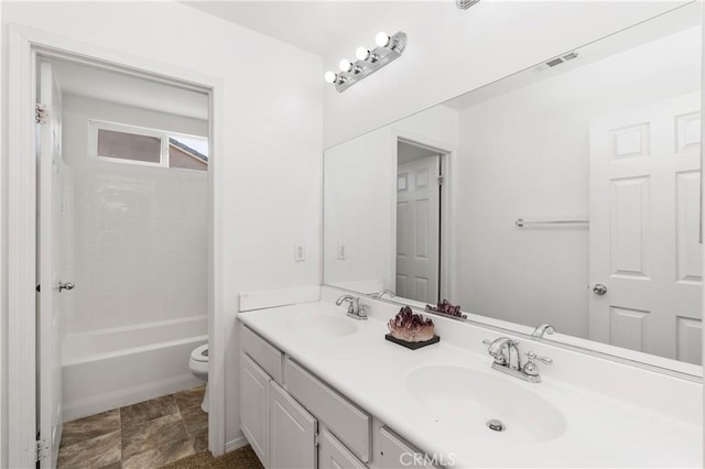 full bathroom featuring toilet, vanity, and  shower combination