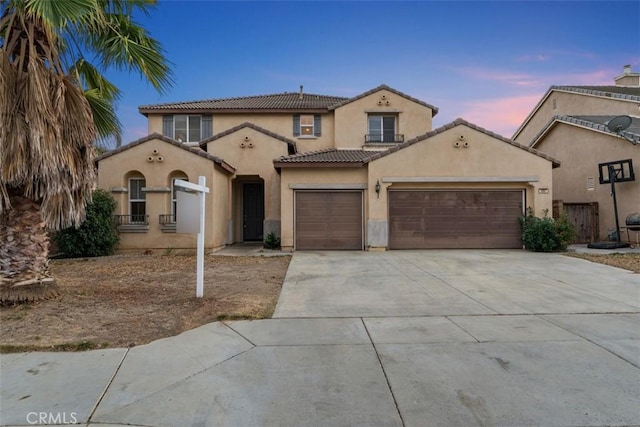 1567 Preston Dr, Perris, CA 92571 - mediterranean / spanish home with an attached garage, stucco siding, concrete driveway, and a tile roof