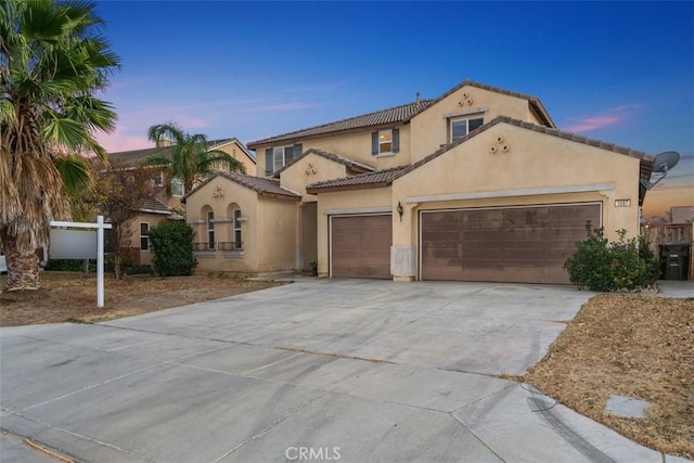 1567 Preston Dr, Perris, CA 92571 - mediterranean / spanish house with a garage, stucco siding, concrete driveway, and a tiled roof