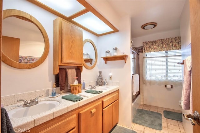 full bathroom featuring shower / bath combination with glass door, vanity, tile patterned floors, and toilet