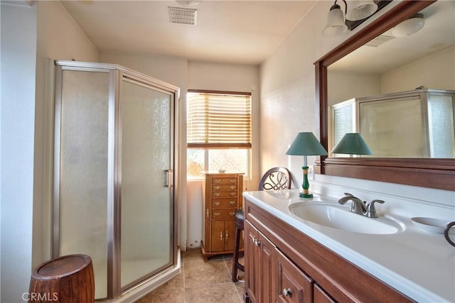 bathroom featuring tile patterned floors, vanity, and an enclosed shower