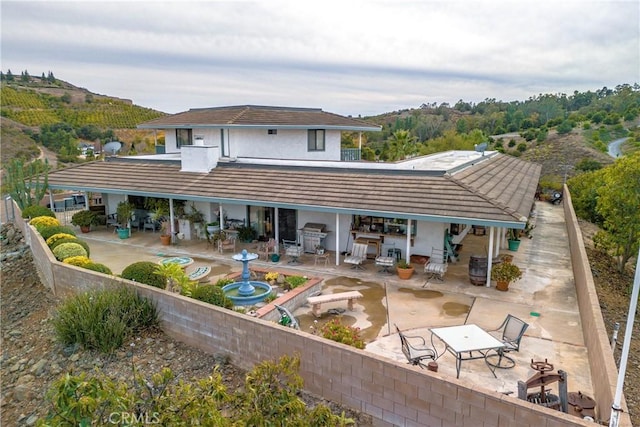 rear view of property with a patio