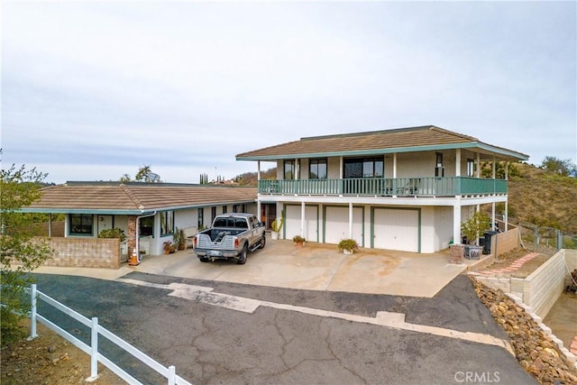 view of front facade featuring a balcony and a garage