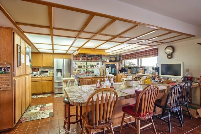 dining area featuring dark tile patterned floors