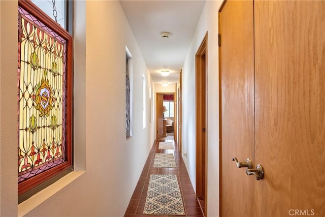 hall featuring dark tile patterned floors