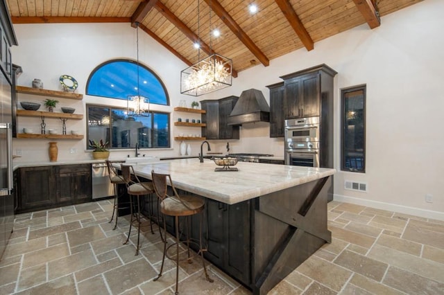 kitchen with stainless steel appliances, custom range hood, high vaulted ceiling, light stone countertops, and a breakfast bar