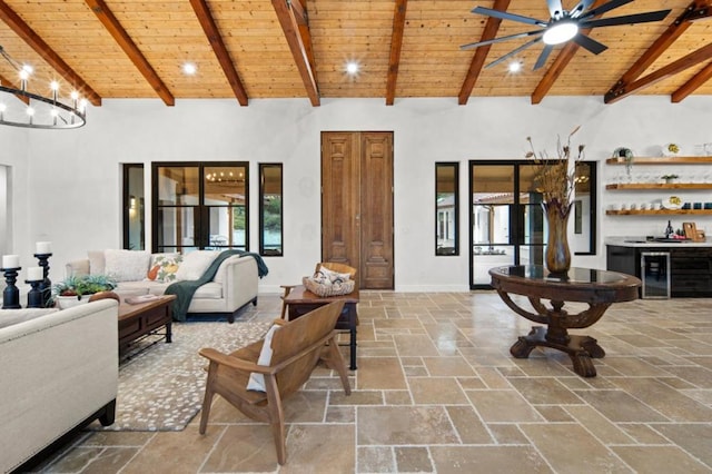 living room with high vaulted ceiling, bar area, beamed ceiling, and wooden ceiling