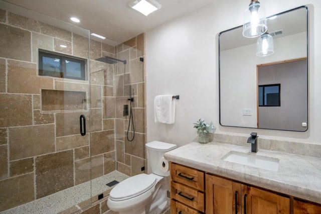 bathroom with a shower with door, toilet, and vanity