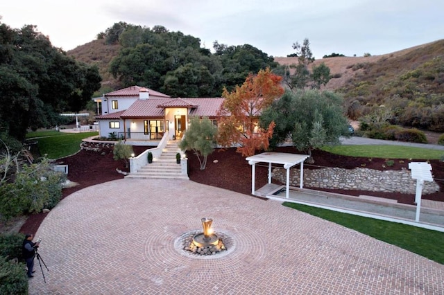 exterior space featuring an outdoor fire pit