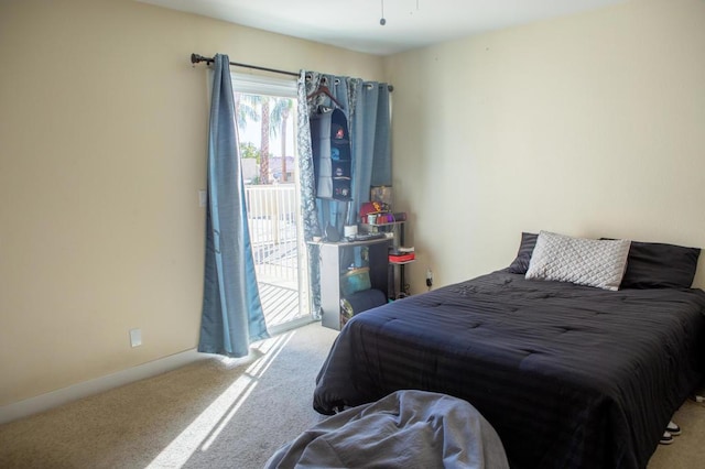 bedroom featuring light carpet and access to outside