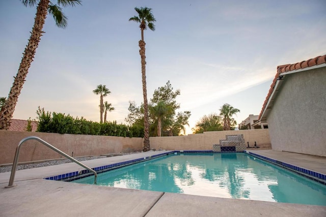 view of pool at dusk