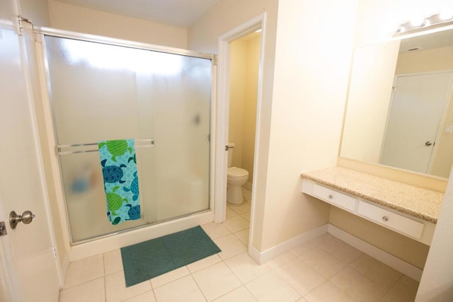 bathroom with toilet, vanity, an enclosed shower, and tile patterned floors