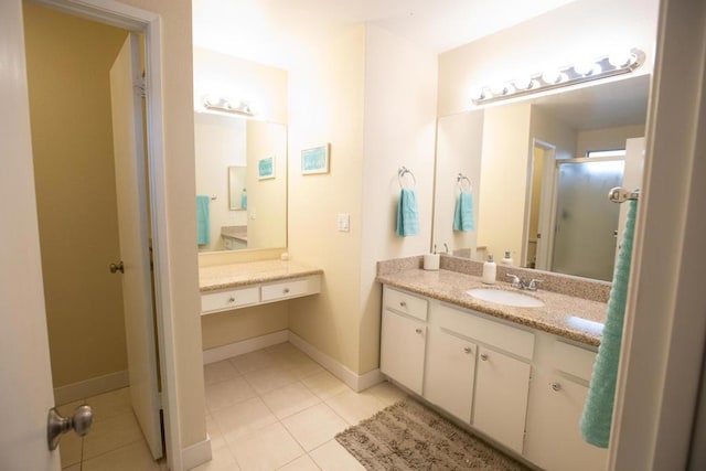 bathroom with vanity, a shower with door, and tile patterned floors