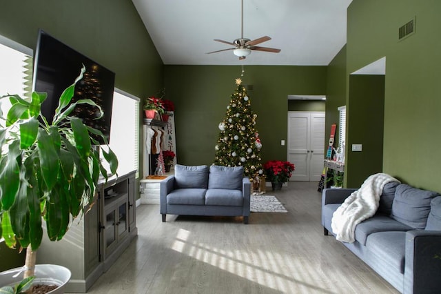 living room featuring ceiling fan and light hardwood / wood-style floors