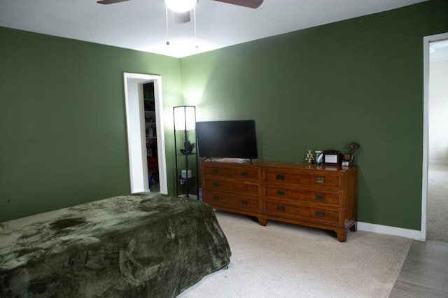 bedroom with ceiling fan and a closet