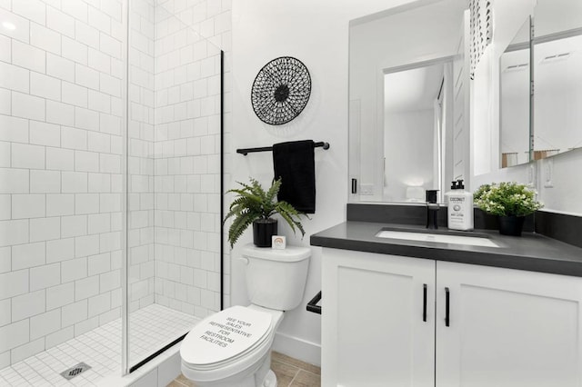 bathroom with vanity, toilet, and a shower with door