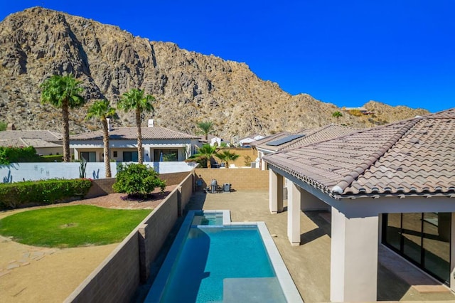 view of swimming pool featuring a patio area and a mountain view