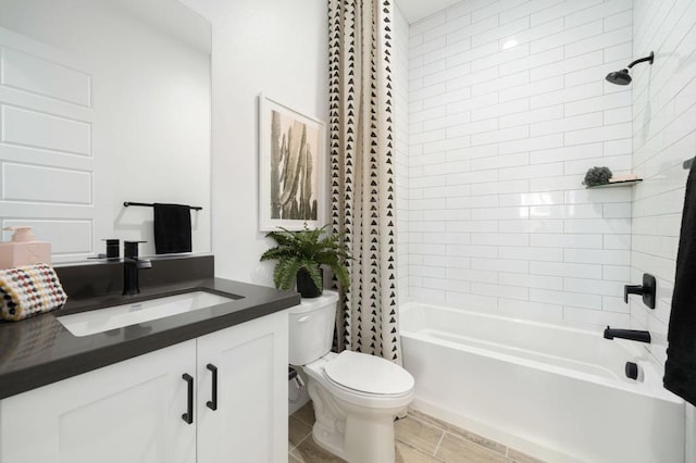 full bathroom featuring toilet, tile patterned floors, vanity, and shower / tub combo with curtain