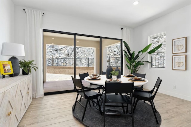 dining room featuring plenty of natural light and light wood-type flooring