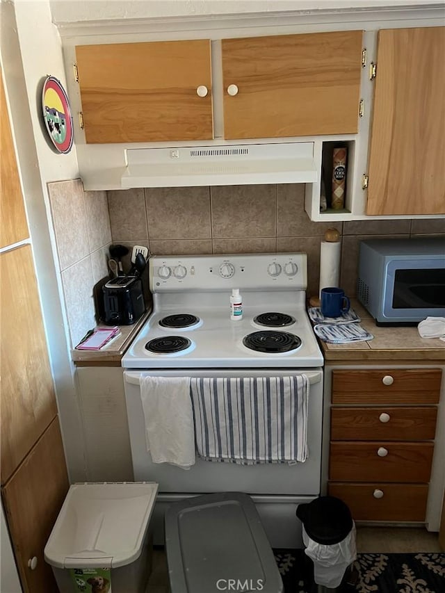 3445 Garfield Ave, Clearlake, CA 95422 - kitchen featuring white electric range, decorative backsplash, under cabinet range hood, light countertops, and brown cabinetry