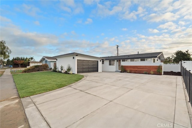 ranch-style house featuring a garage and a front yard