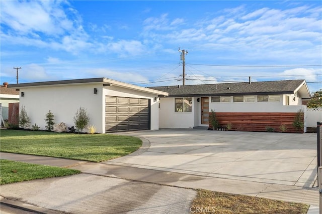 ranch-style house with a front yard and a garage