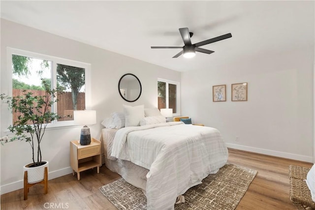 bedroom with ceiling fan and light hardwood / wood-style flooring