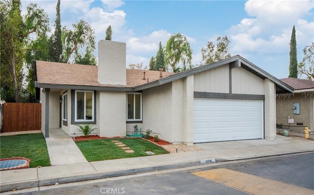 ranch-style house featuring a front lawn and a garage