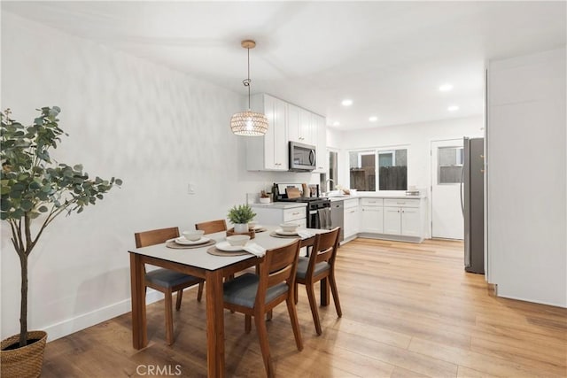 dining area featuring light hardwood / wood-style floors and sink