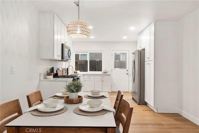 dining room with a chandelier and light hardwood / wood-style floors