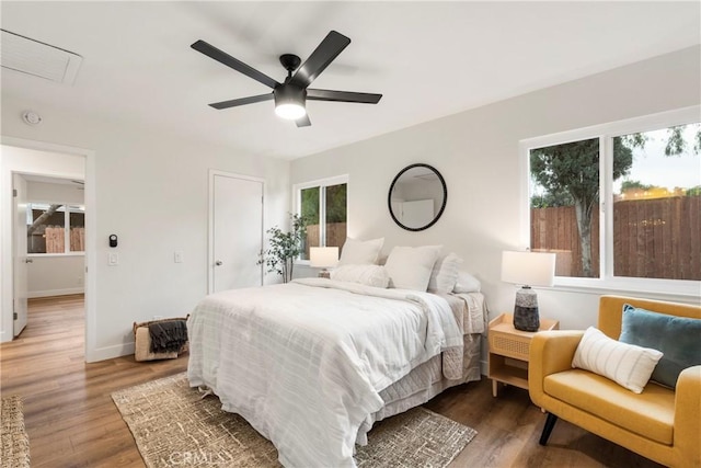 bedroom with ceiling fan and dark hardwood / wood-style floors