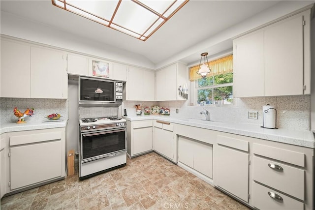 kitchen with tasteful backsplash, white cabinetry, sink, and range with gas cooktop