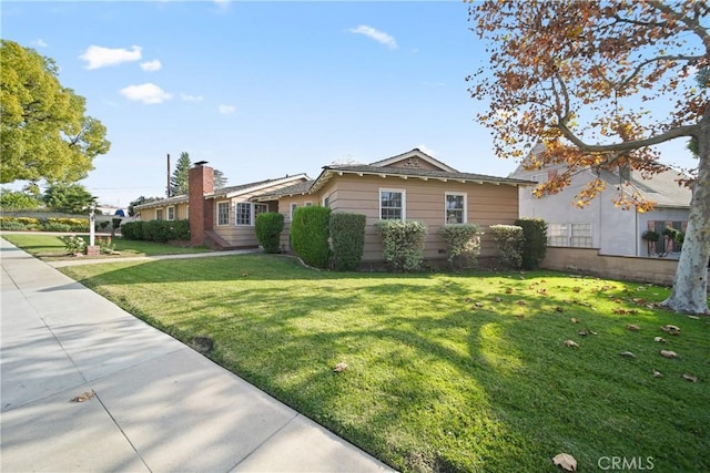 view of property exterior featuring a lawn