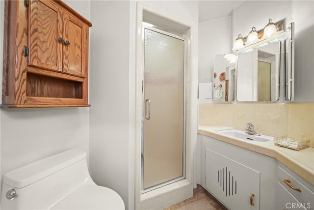 bathroom with vanity, toilet, and a shower with door